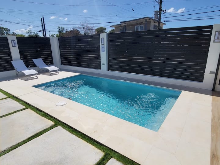 Sun loungers by the pool at Isabela Escape House