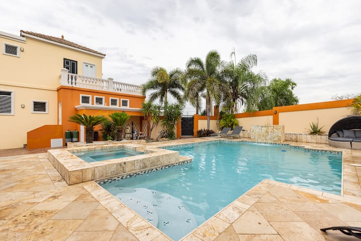 Pool and spa with travertine terrace at Oasis Escape House