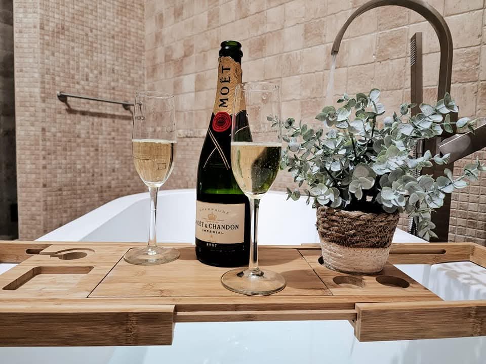 Champagne and glasses served on the bath tray