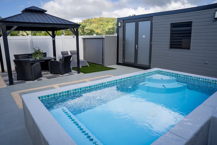 Turquoise-tiled pool and gazebo at Westside Escape