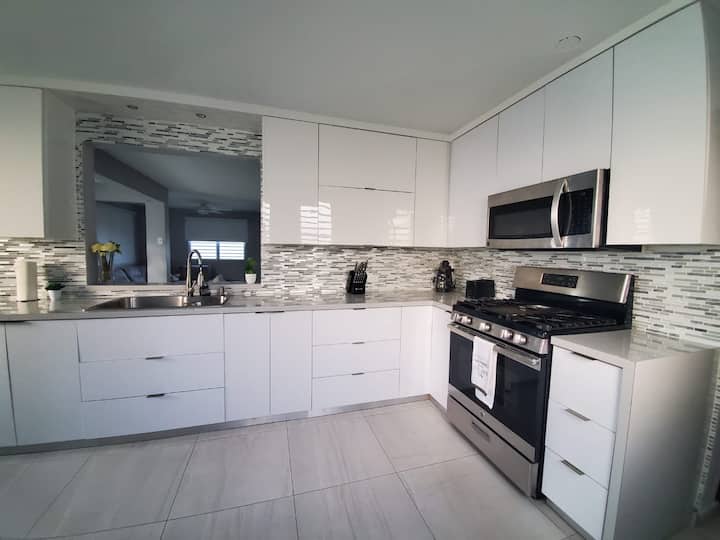 Modern white kitchen with gas range at Isabela Escape House