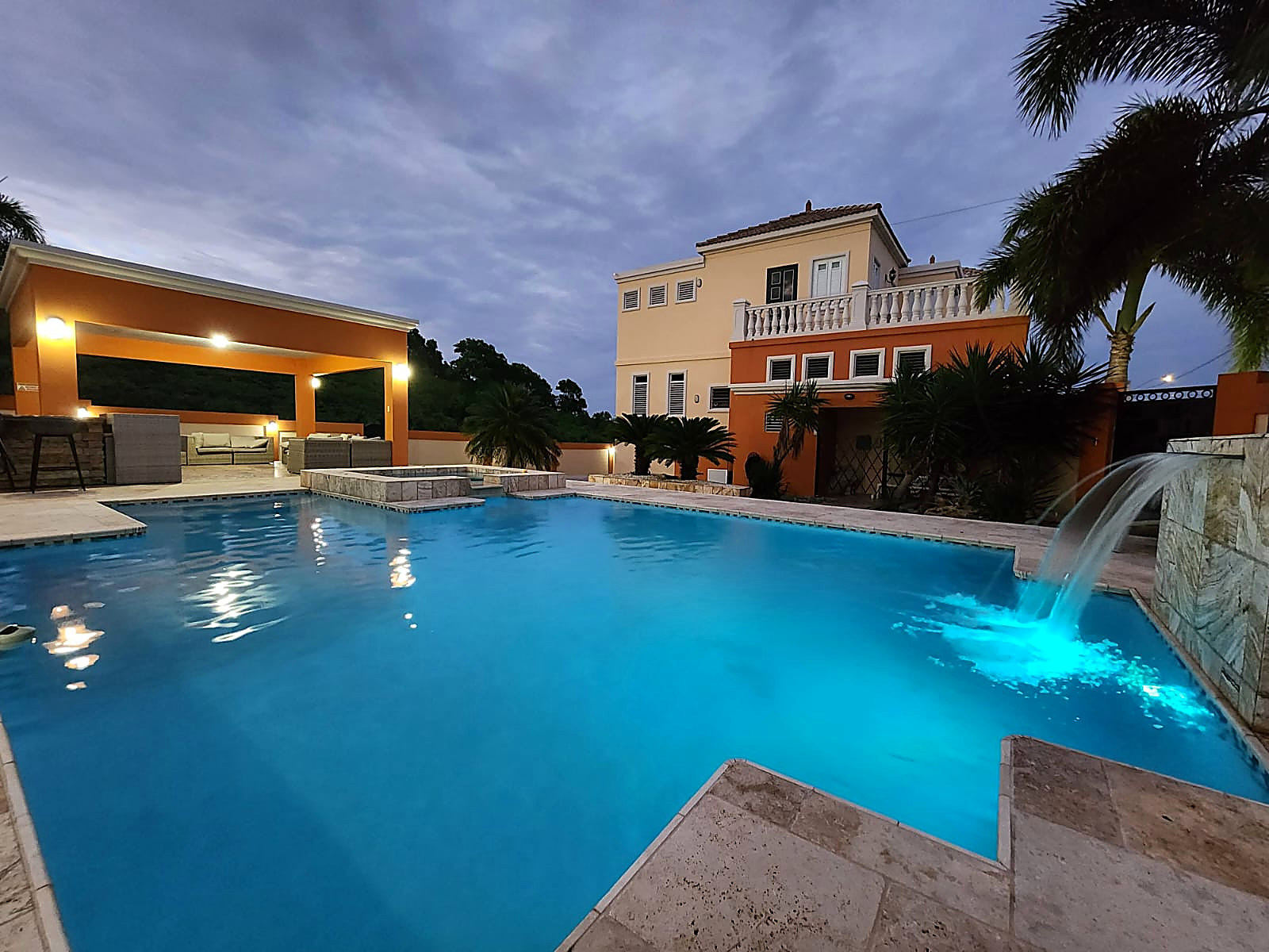 Pool with its water feature and the villa at dusk, Oasis Escape House, Camuy